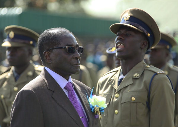 Zimbabwean President Robert Mugabe inspects an honor guard of police officers Thursday in Harare, the country's capital. (Tsvangirayi Mukwazhi / Associated Press / June 13, 2013)