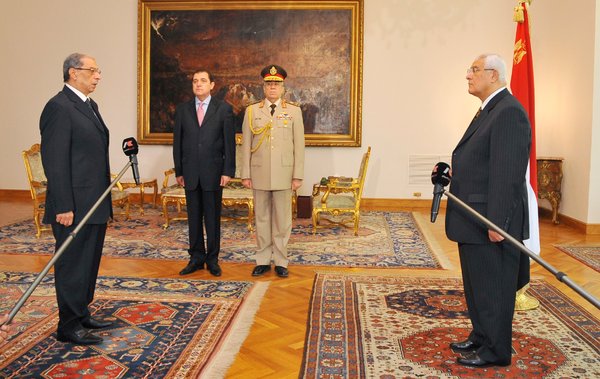 Newly-appointed prosecutor general Hisham Barakat, left, is sworn in in front of interim president, Adli Mansour, right, at the presidential palace in Cairo on Wednesday.
