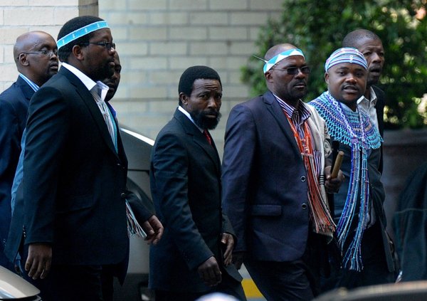King Buyelekhaya Dalindyebo, center, flanked by tribal chiefs, arrives to visit former South African President Nelson Mandela at a Pretoria hospital. (Alexander Joe / AFP/ Getty Images / July 9, 2013)
