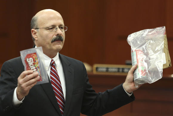 Assistant state attorney Bernie de la Rionda holds up evidence to the jury while presenting the state's closing arguments against George Zimmerman during his trial in Seminole circuit court in Sanford, Fla. Thursday, July 11, 2013. Zimmerman has been charged with second-degree murder for the 2012 shooting death of Trayvon Martin. (Gary W. Green/Orlando Sentinel) (Gary W. Green / Orlando Sentinel / July 10, 2013)