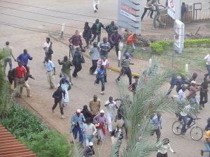 Crowds flee mall in Nairobi as gunfire erupts.