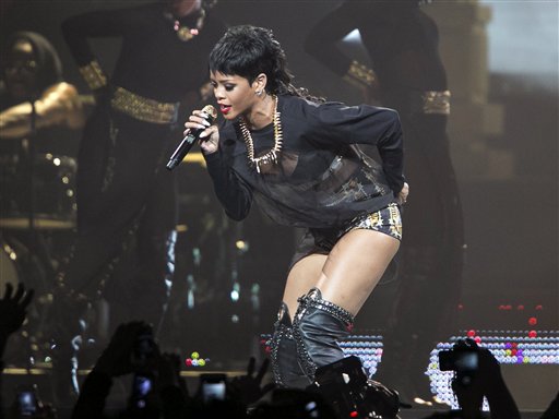 FILE - In this Sept. 24, 2013 file photo, Rihanna performs in Perth, Australia during the first concert of the Australian leg of her Diamonds World Tour. Thai authorities arrested a bar owner in connection with a lewd sex show mentioned in racy tweets by pop star Rihanna during her recent trip to Thailand, officials said Monday, Oct. 14, 2013, two weeks after an Instagram photo of her with a protected primate led to the arrest of other two men. (AP Photo/Lee Griffith, File)