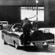 FILE - In this Nov. 22, 1963 file photo, President John F. Kennedy slumps down in the back seat of the Presidential limousine as it speeds along Elm Street toward the Stemmons Freeway overpass after being fatally shot in Dallas. Mrs. Jacqueline Kennedy leans over the president as Secret Service agent Clinton Hill rides on the back of the car. (AP Photo/Ike Altgens, File)