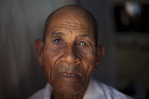 In this Nov. 12, 2013 photo, Calmelo Novas, 84, one of many people of Haitian descent fearing the effects of a recent Dominican court ruling on citizenship, sits in the doorway of his home in Jimani, Dominican Republic, near the border with Haiti. A Dominican Constitutional Court ruling that being born in the country does not automatically grant citizenship is a reflection of deep hostility in the Dominican Republic to the vast number of Haitians who have come to live in their country, many brought over to work in the sugar industry. (AP Photo/Dieu Nalio Chery)