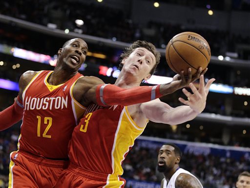 Houston Rockets' Dwight Howard, left, and Omer Asik, of Turkey, reach for a rebound during the first half of an NBA basketball game against the Los Angeles Clippers on Monday, Nov. 4, 2013, in Los Angeles. The Clippers won 137-118. (AP Photo/Jae C. Hong)