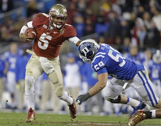 Florida State's Jameis Winston (5) scrambles as Duke's Kelby Brown (59) defends in the first half of the Atlantic Coast Conference Championship NCAA football game in Charlotte, N.C., Saturday, Dec. 7, 2013. (AP Photo/Bob Leverone)