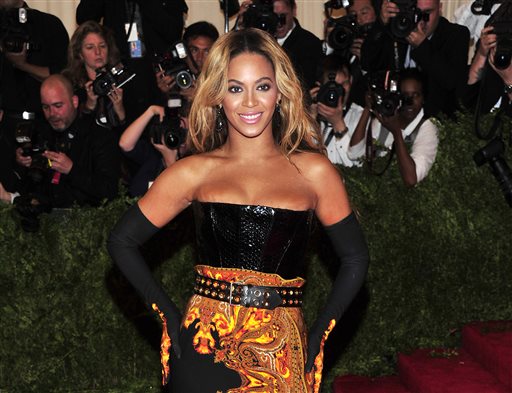 This May 6, 2013 file photo shows singer Beyonce at The Metropolitan Museum of Art's Costume Institute benefit in New York.  Beyonce has released her new album in an unconventional way: She announced and dropped it on the same day. The singer released "Beyonce" exclusively on iTunes early Friday, Dec. 13.  (Photo by Charles Sykes/Invision/AP, File)