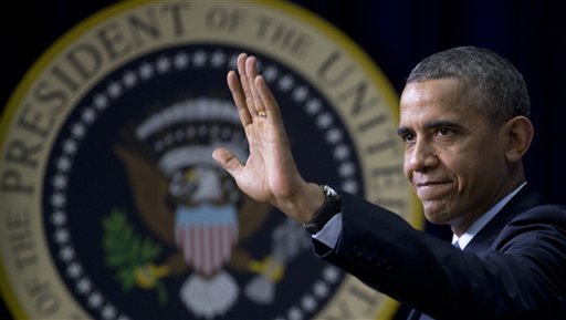 President Barack Obama waves to the audience after speaking ay a World AIDS Day event, Monday, Dec. 2, 2013, in the South Court Auditorium in the Eisenhower Executive Office Building on the White House complex in Washington. The president announced a new initiative at the National Institutes of Health in pursuit of a cure for HIV. Obama said his administration is redirecting $100 million into the project to find a new generation of therapies. He said the United States should be at the forefront of discoveries to eliminate HIV or put it into remission without requiring lifelong. (AP Photo/Carolyn Kaster)