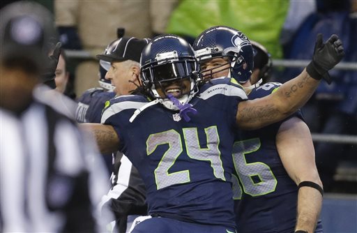 Seattle Seahawks running back Marshawn Lynch celebrates after running for a 31-yard touchdown against the New Orleans Saints during the fourth quarter of an NFC divisional playoff NFL football game in Seattle, Saturday, Jan. 11, 2014. (AP Photo/Ted S. Warren)