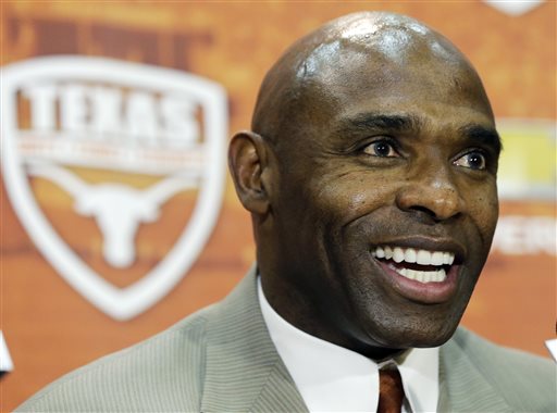 Charlie Strong answers questions during an NCAA college football news conference where he was introduced as the new Texas football coach, Monday, Jan. 6, 2014, in Austin, Texas. Strong acknowledged the historical significance of being the school's first African-American head coach of a men's sport. He takes over for Mack Brown, who stepped down last month after 16 seasons. (AP Photo/Eric Gay)