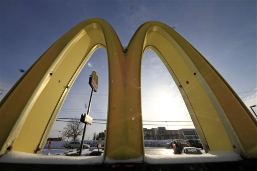 In this Tuesday, Jan. 21, 2014, photo, cars drive past the McDonald's Golden Arches logo at a McDonald's restaurant in Robinson Township, Pa. McDonald's reports quarterly earnings on Thursday, Jan. 23, 2014.  (AP Photo/Gene J. Puskar)