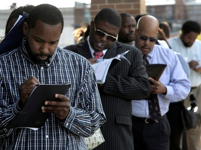 Jamal Randle, from left, Loren Cowling, and Dave Jackson fill out applications for positions at a new bar and restaurant in Detroit, Sept. 25, 2009. (AP Photo/Paul Sancya)