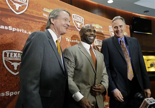 Charlie Strong, center, poses with Texas president Bill Powers, left, and athletic director Steve Patterson, right, following an NCAA college football news conference where he was introduced as the new Texas football coach, Monday, Jan. 6, 2014, in Austin, Texas. Strong takes over for Mack Brown, who stepped down last month after 16 seasons. (AP Photo/Eric Gay)