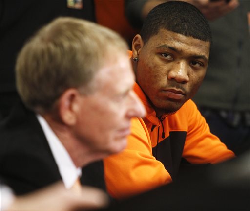Oklahoma State basketball player Marcus Smart, right, and OSU athletic director Mike Holder look on during during a news conference in Stillwater, Okla., Sunday, Feb. 9, 2014, in regard to Smart shoving a fan during an NCAA college basketball game the day before. (AP Photo/The Oklahoman, KT King) 