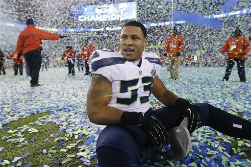 Seattle Seahawks' Malcolm Smith sits on the field after the NFL Super Bowl XLVIII football game against the Denver Broncos Sunday, Feb. 2, 2014, in East Rutherford, N.J. The Seahawks won 43-8. (AP Photo/Ben Margot)