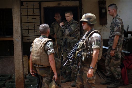 French soldiers search a house used as an armed cache in the Christian sector of PK12, the last checkpoint at the exit of the town, in Bangui, Central African Republic Tuesday Feb. 11, 2014 (AP Photo/Jerome Delay)