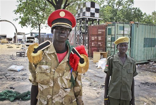 In this photo taken Wednesday, Feb. 26, 2014, rebels proclaiming to be part of the Nuer tribe's infamous 'White Army' stand in the grounds of the hospital in Malakal, South Sudan. (AP Photo/Ilya Gridneff)