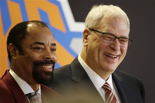 Former New York Knicks player Walt Frazier, left,  joins Phil Jackson, the newly named president of the Knicks, at a news conference Tuesday, March 18, 2014 in New York. Frazier and Jackson are former teammates with the Knicks. (AP Photo/Mark Lennihan)