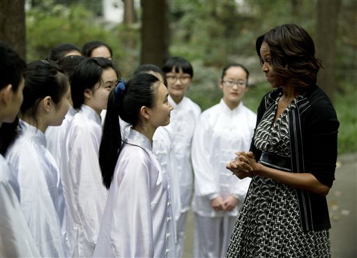 U.S. first lady Michelle Obama, right, chats with students after practicing tai chi  with them at Chengdu No.7 High School in Chengdu in southwest China's Sichuan province Tuesday, March 25, 2014. (AP Photo/Andy Wong)