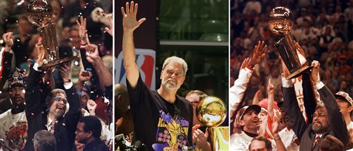 At left, in a  June 13, 1997, file photo, Chicago Bulls coach Phil Jackson hoists the NBA Championship trophy aloft after the Bulls beat the Utah Jazz 90-86 in Game 6 of the NBA Finals. in Chicago. At center, in a June 21, 2000 file photo, Los Angeles Lakers head coach Phil Jackson waves to the crowd as the Lakers and thousands of their fans celebrate their NBA Championship in downtown Los Angeles. At right, in a June 16, 1996 file photo, Chicago Bulls coach Phil Jackson hoists the NBA championship trophy after the Bulls beat Seattle in Game 6 of the NBA Finals in Chicago. (AP Photo/File)