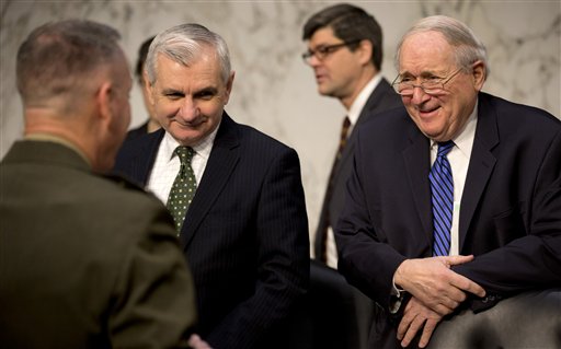 Senate Armed Services Committee Chairman Sen. Carl Levin, D-Mich., right, and Sen. Jack Reed, D-R.I., center, talk with Marine Gen. Joseph F. Dunford, Jr., left, Commander, International Security Assistance Force, on Capitol Hill in Washington, Wednesday, March 12, 2014, before the committee's hearing on the situation in Afghanistan. (AP Photo/Carolyn Kaster)