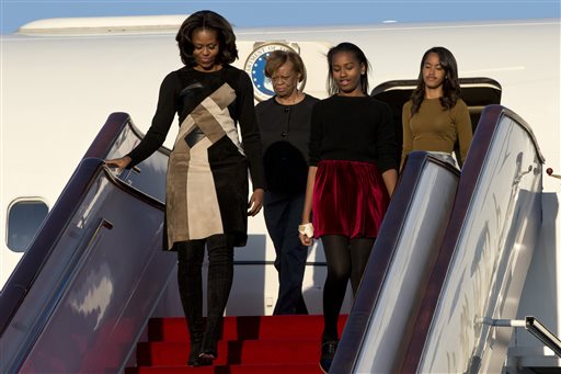 U.S. First Lady Michelle Obama, front left, her daughters Sasha, front right, Malia, right in the back, and Michelle Obama's mother Marian Robinson, left in the back, arrive at Capital International Airport in Beijing, China, Thursday, March 20, 2014. (AP Photo/Alexander F. Yuan, Pool)