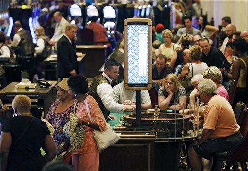 In this June 29, 2012 file photo, patrons gamble on the main gaming floor at the Horseshoe Casino in Cleveland. An industry report released Wednesday, March 26, 2014 said 2012 revenue growth by commercial casinos, such as Horseshoe Casino, outpaced that by Indian-owned casinos for the first time in nearly 20 years. (AP Photo/Mark Duncan, File)