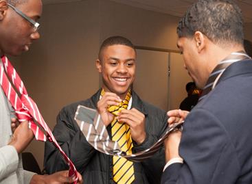 Fonzworth Bentley teaches students the proper way to tie a Windsor knot at the “Tied to Greatness” workshop during the UNCF Empower Me Tour presented by Wells Fargo in Charlotte, NC.