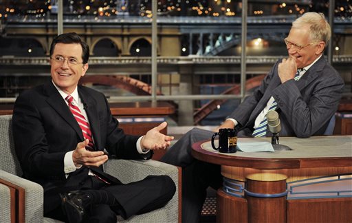 In this May 3, 2012 photo provided by CBS, Stephen Colbert, left, host of the Colbert Report on the Comedy Central Network, has a laugh on stage with host David Letterman on the set of the Late Show with David Letterman, in New York. CBS announced on Thursday, April 10, 2014 that Colbert will replace Letterman as Late Show host after Letterman retires in 2015. (AP Photo/CBS, John Paul Filo)