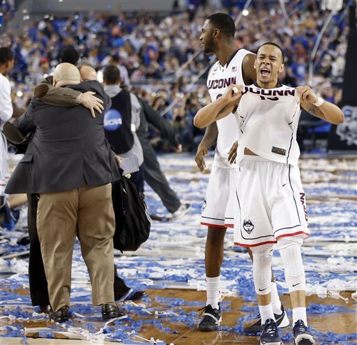 Connecticut guard Shabazz Napier (13) celebrates a 60-54 win over Kentucky in the 2014 NCAA Division I men's basketball championship at AT&T Stadium in Arlington, Texas on Monday, April 7, 2014. (AP Photo/The Dallas Morning News,Vernon Bryant)