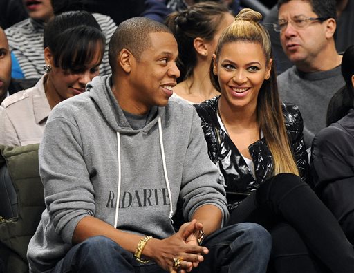 This Nov. 23, 2012 file photo shows entertainers Jay Z and his wife Beyonce at the Brooklyn Nets against the Los Angeles Clippers NBA basketball game at Barclays Center in New York. The couple will launch the co-headlining "On the Run Tour" on June 25 in Miami. (AP Photo/Kathy Kmonicek, File)
