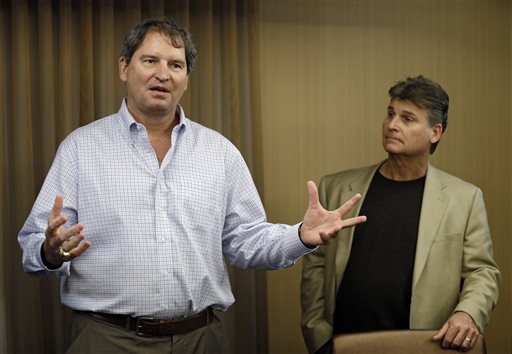 In this Jan. 10, 2013 file photo, former Cleveland Browns quarterback Bernie Kosar, left, speaks at a news conference with Dr. Rick Sponaugle, in Middleburg Heights, Ohio . Thursday, Jan. 10, 2013. Kosar believes he's been unfairly sacked as a TV broadcaster. Kosar contends he's been removed because of slurred speech he attributes to "a direct result of the many concussions I received while playing in the NFL." (AP Photo/Mark Duncan, File)