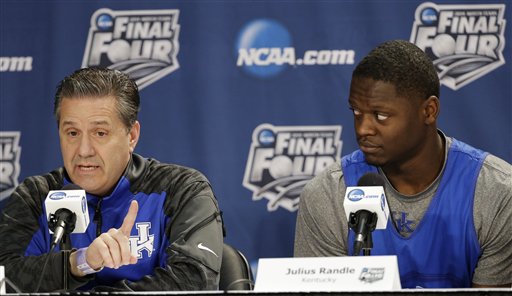 Kentucky head coach John Calipari, left, answers a question as forward Julius Randle looks on during a news conference for the NCAA Final Four tournament college basketball championship game Sunday, April 6, 2014, in Arlington, Texas. Kentucky plays Connecticut in the championship game on Monday, April 7. 2014. (AP Photo/Tony Gutierrez)