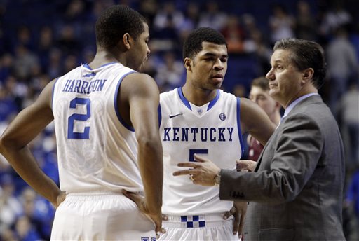 In this Jan. 21, 2014 file photo, Kentucky head coach John Calipari, right, instructs Aaron Harrison (2) and Andrew Harrison (5) during the second half of an NCAA college basketball game in Lexington, Ky. The Kentucky twin freshman guards will return for a second season to a stocked Wildcats squad coming off an NCAA championship appearance. (AP Photo/James Crisp, File)