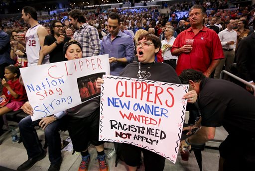 Fans hold up signs in support of the Los Angeles Clippers before Game 5 of an opening-round NBA basketball playoff series between the Clippers and the Golden State Warriors on Tuesday, April 29, 2014, in Los Angeles. NBA Commissioner Adam Silver announced Tuesday that Clippers owner Donald Sterling has been banned for life by the league. (AP Photo/Ringo H.W. Chiu)