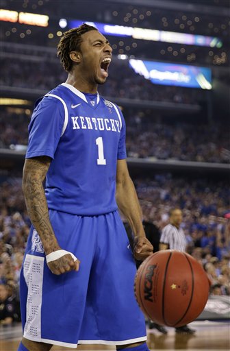 Kentucky guard James Young reacts after dunking the ball during the second half of the NCAA Final Four tournament college basketball championship game against Connecticut Monday, April 7, 2014, in Arlington, Texas. (AP Photo/David J. Phillip)