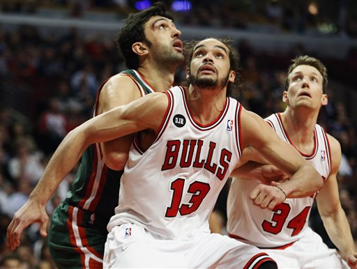 In this April 4, 2014 file photo, Chicago Bulls center Joakim Noah (13) defends against Milwaukee Bucks center Zaza Pachulia during an NBA basketball game in Chicago.  A person familiar with the situation says that Noah is the NBA's Defensive Player of the Year. The person spoke Monday, April 21, 2014 on the condition of anonymity because the award had not been announced. (AP Photo/Kamil Krzaczynski, File)