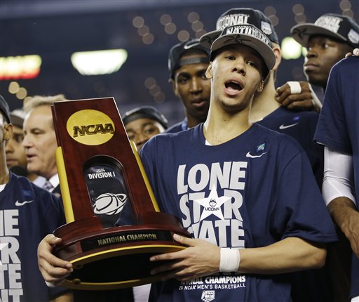 Connecticut guard Shabazz Napier holds the championship trophy after defeating Kentucky 60-54, at the NCAA Final Four tournament college basketball championship game Monday, April 7, 2014, in Arlington, Texas. (AP Photo/David J. Phillip)