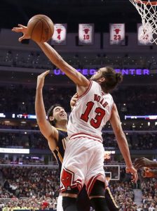 In this March 24, 2014 file photo, Chicago Bulls center Joakim Noah (13) blocks the shot of Indiana Pacers forward Luis Scola during the first half of an NBA basketball game in Chicago. A person familiar with the situation says Bulls center Joakim Noah is the NBA's Defensive Player of the Year. The person spoke Monday, April 21, 2014, on the condition of anonymity because the award had not been announced. (AP Photo/Charles Rex Arbogast, File)