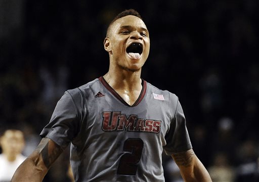 In this Dec. 28, 2013 file photo, UMass guard Derrick Gordon celebrates after hitting the go-ahead basket with one second left on the clock during overtime of an NCAA college basketball game against Providence, in Amherst, Mass. Gordon says in a televised interview that he is gay. Gordon made the announcement on ESPN on Wednesday, April 9, 2014, becoming the first openly gay player in Division I men's basketball.  (AP Photo/Jessica Hill, File)