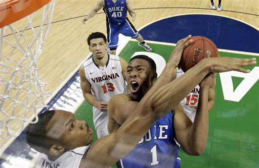 In this March 16, 2014 file photo, Duke's Jabari Parker (1) tries to shoot over Virginia's Darion Atkins during the first half of an NCAA college basketball game in the championship of the Atlantic Coast Conference tournament in Greensboro, N.C. Parker was selected to The Associated Pressnam All-America team, released Monday, March 31, 2014.  (AP Photo/Bob Leverone, File)
