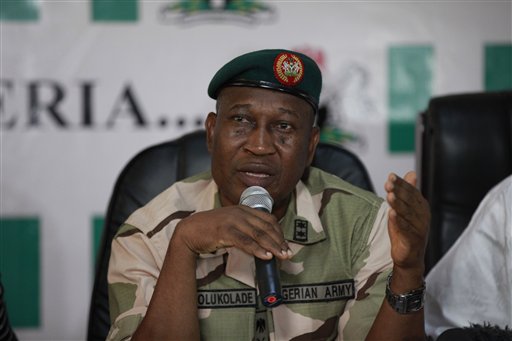 Brig. Gen. Chris Olukolade, Nigeria's top military spokesman, speaks during a press conference on the abducted school girls in Abuja, Nigeria, Monday, May 12, 2014. A Nigerian Islamic extremist leader says nearly 300 abducted schoolgirls will not be seen again until the government frees his detained fighters. A new video from Nigeria's homegrown Boko Haram terrorist network received Monday purports to show some of the girls and young women chanting Quranic verses in Arabic. The barefoot girls look frightened and sad and sit huddled together wearing gray Muslim veils. Some Christians among them say they have converted to Islam. (AP Photo/Sunday Alamba)