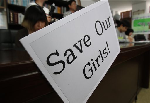 Christians pray during a service to support the release of kidnapped girls in Nigeria, at a church in Seoul, South Korea, Wednesday, May 14, 2014. Boko Haram, the militant group that kidnapped nearly 300 schoolgirls in Nigeria, said the girls will only be freed after the government releases jailed militants. (AP Photo/Ahn Young-joon)