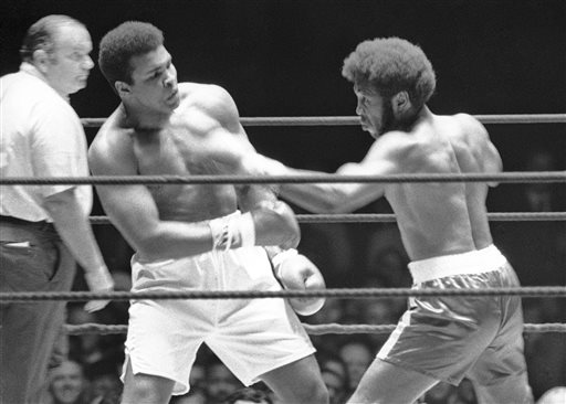 In this July 27, 1971, file photo, Referee Jay Edson, left, keeps an eye on the fight between Muhammad Ali and Jimmy Ellis, right, in the 12th round of their heavyweight fight in Houston. Ellis, a former heavyweight boxing champion who trained with fellow Louisville fighter Muhammad Ali and squared off against some of his era's best fighters, has died in his hometown Tuesday, May 6, 2014. He was 74. Ellis' brother, Jerry, said the ex-champion died at a Louisville hospital Tuesday after suffering from Alzheimer's disease in recent years. (AP Photo/File)