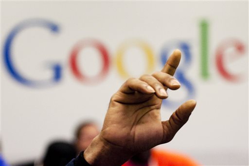 In this Oct. 17, 2012, file photo, a man raises his hand during at Google offices in New York. People should have some say over the results that pop up when they conduct a search of their own name online, Europe's highest court said Tuesday, May 13, 2014. (AP Photo/Mark Lennihan, File)