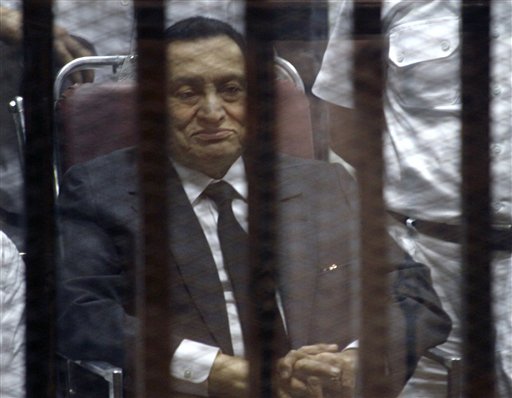Ousted Egyptian President Hosni Mubarak, sits in the defendants cage behind protective glass, during a court hearing in Cairo, Egypt, Wednesday, May 21, 2014. An Egyptian court has convicted Mubarak of embezzlement and sentenced him to three years in prison. Mubarak's two sons, one-time heir apparent Gamal and wealthy businessman Alaa, were also convicted Wednesday of graft and sentenced to four years in prison each in the same case. (AP Photo/Tarek el-Gabbas)