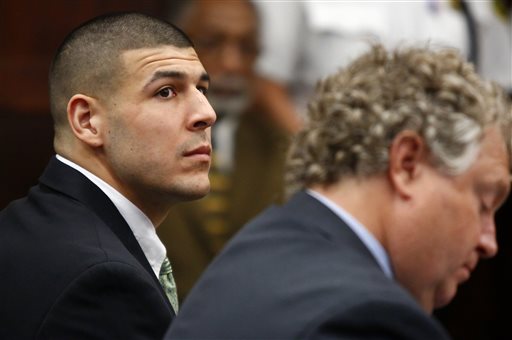 Former New England Patriots tight end Aaron Hernandez listens to the prosecution's summary of facts as he is arraigned on homicide charges at Suffolk Superior Court in Boston, Wednesday, May 28, 2014. Hernandez pleaded not guilty in the shooting deaths of Daniel de Abreu and Safiro Furtado. He already faces charges in the 2013 killing of semi-pro football player Odin Lloyd. (AP Photo/Dominick Reuter, Pool)