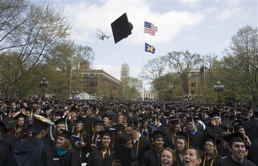 In this  Saturday, April 26, 2008, file photo, University of Michigan graduates celebrate after their spring commencement ceremony, in Ann Arbor, Mich. (AP Photo/Tony Ding, File)