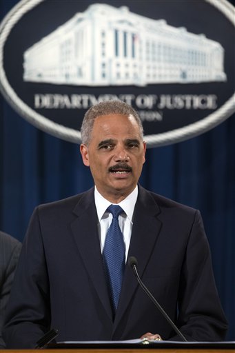Attorney General Eric Holder speaks during a news conference at the Justice Department, on Monday, May 19, 2014, in Washington. The Justice Department on Monday charged Credit Suisse AG with helping wealthy Americans avoid paying taxes through offshore accounts, and a person familiar with the matter said the European bank has agreed to pay about $2.6 billion in penalties. (AP Photo/ Evan Vucci)