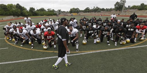 In this Aug. 16, 2013, photo, Alabama State football coach Reggie Barlow talks with his players following practice at the school in Montgomery, Ala. Seventeen of the teams banned by the NCAA for sub-par scores on the newest Academic Progress Rate are in football or mens basketball. Eight of those are historically black colleges including the only two schools to make the list in both sports: Alabama State and Florida A&M. The money gap at Division I colleges is continuing to show up on the playing fields and in the classrooms. Thirty-six teams will be banned from the 2014-15 postseason because of sub-par scores on the newest APR, which was released Wednesday, May 14, 2014. Not one of them comes from a power conference. (AP Photo/Dave Martin)